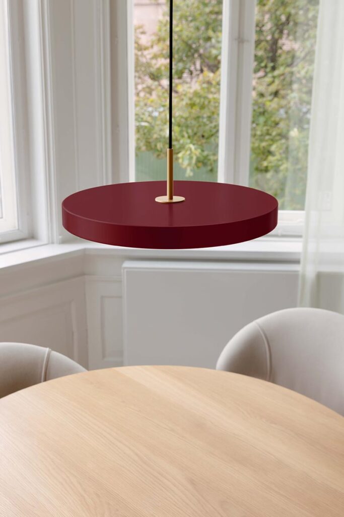 hanging pendant light over dining table by Umage